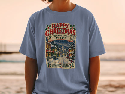 T-shirt with "Happy Christmas From Our Little Village" and winter scene.