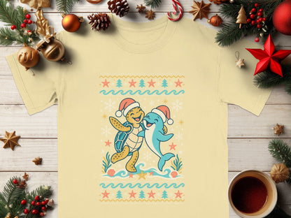 Yellow t-shirt with cartoon turtle and dolphin wearing Santa hats.