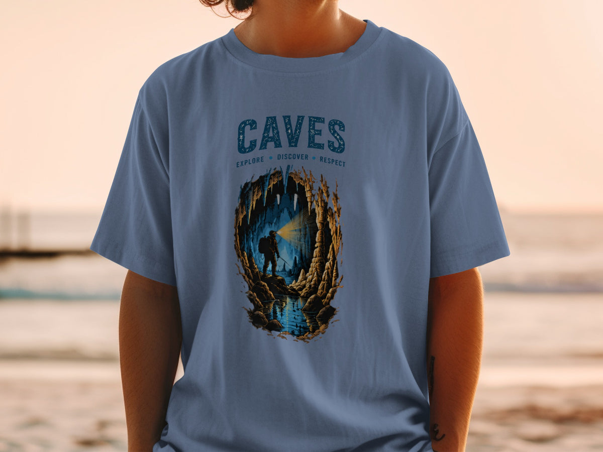 Blue t-shirt with "CAVES EXPLORE DISCOVER RESPECT" text and cave illustration.