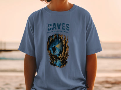 Blue t-shirt with "CAVES EXPLORE DISCOVER RESPECT" text and cave illustration.