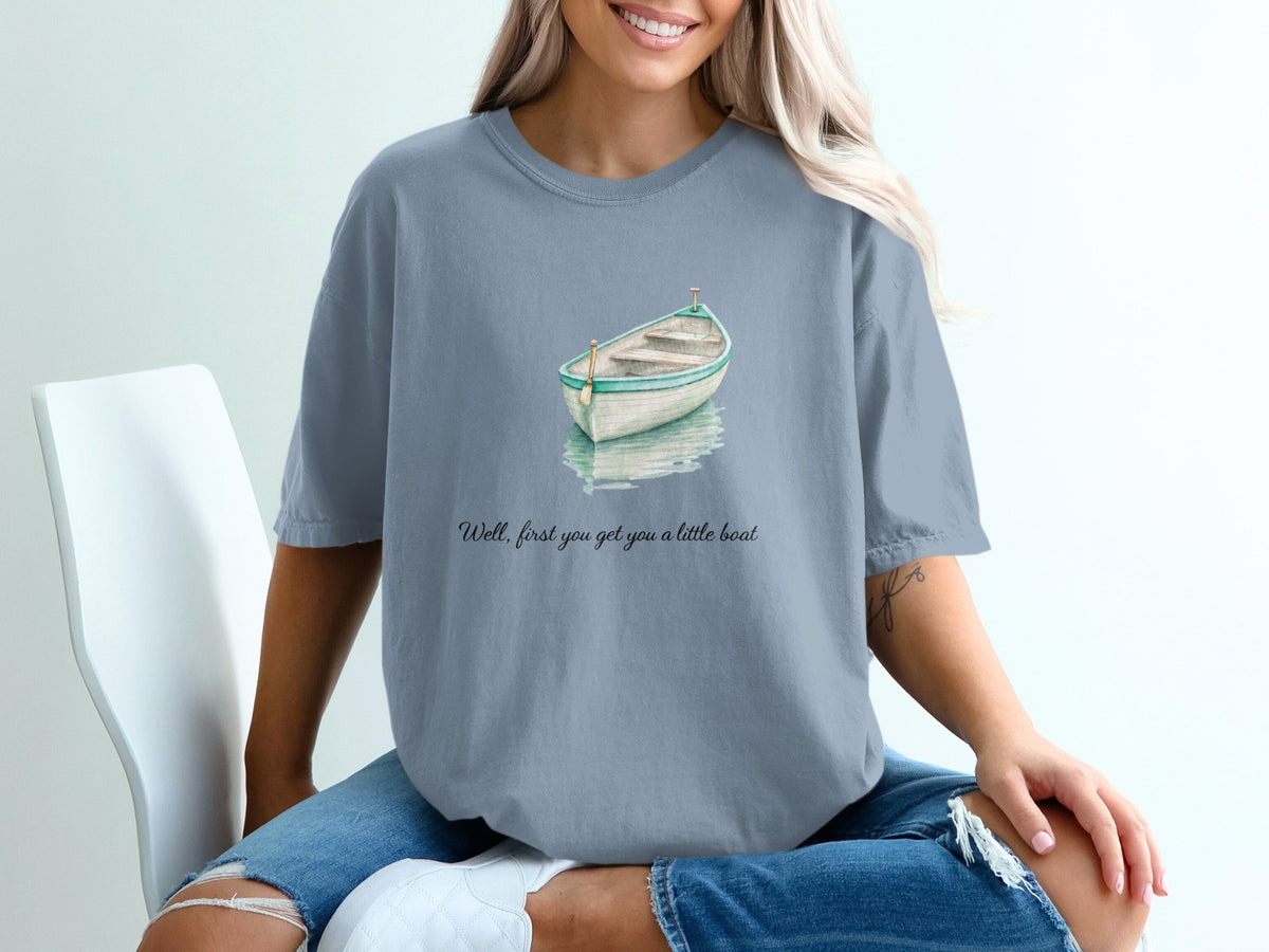 T-shirt with watercolor boat graphic and text "Well, first you get you a little boat."