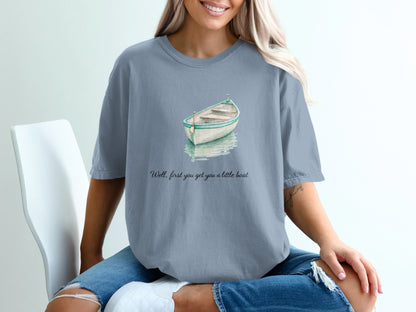 T-shirt with watercolor boat graphic and text "Well, first you get you a little boat."