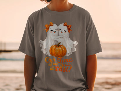 Two cute ghosts hug with a pumpkin, "Our Time of the Year, at Last!"
