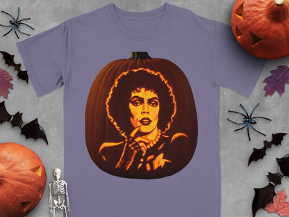 A purple t-shirt featuring a lit jack-o'-lantern carved with the face of Frank-N-Furter from The Rocky Horror Picture Show.