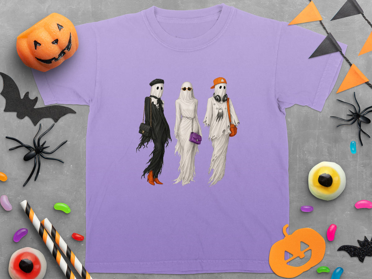Three ghosts dressed in stylish Halloween outfits on a lavender t-shirt.