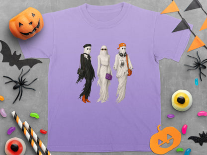 Three ghosts dressed in stylish Halloween outfits on a lavender t-shirt.