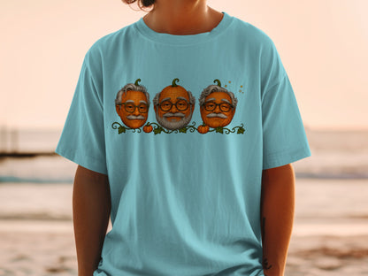 T-shirt with three pumpkins dressed as elderly men with glasses and mustaches.