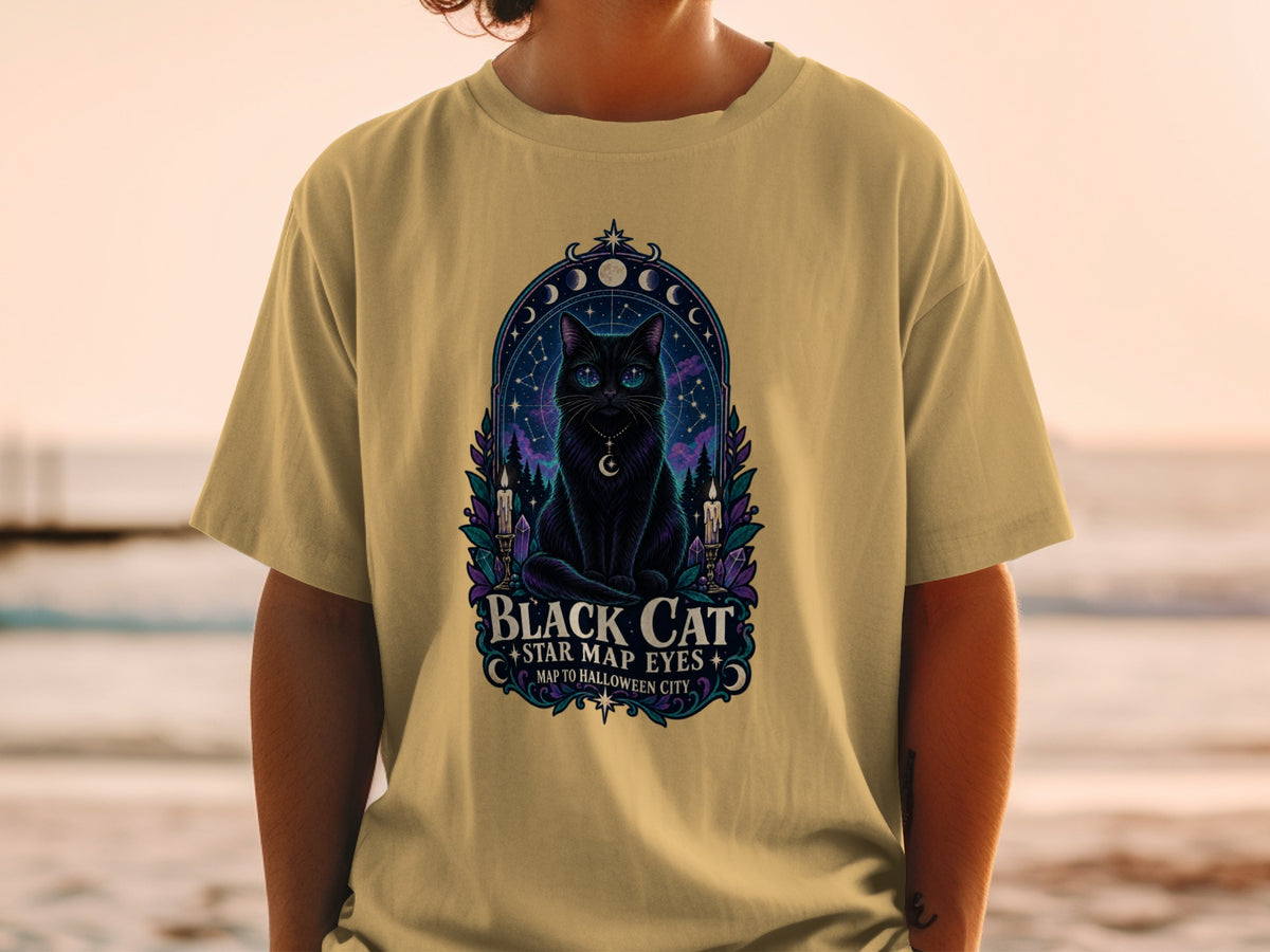 T-shirt with a black cat illustration, celestial background, and text.