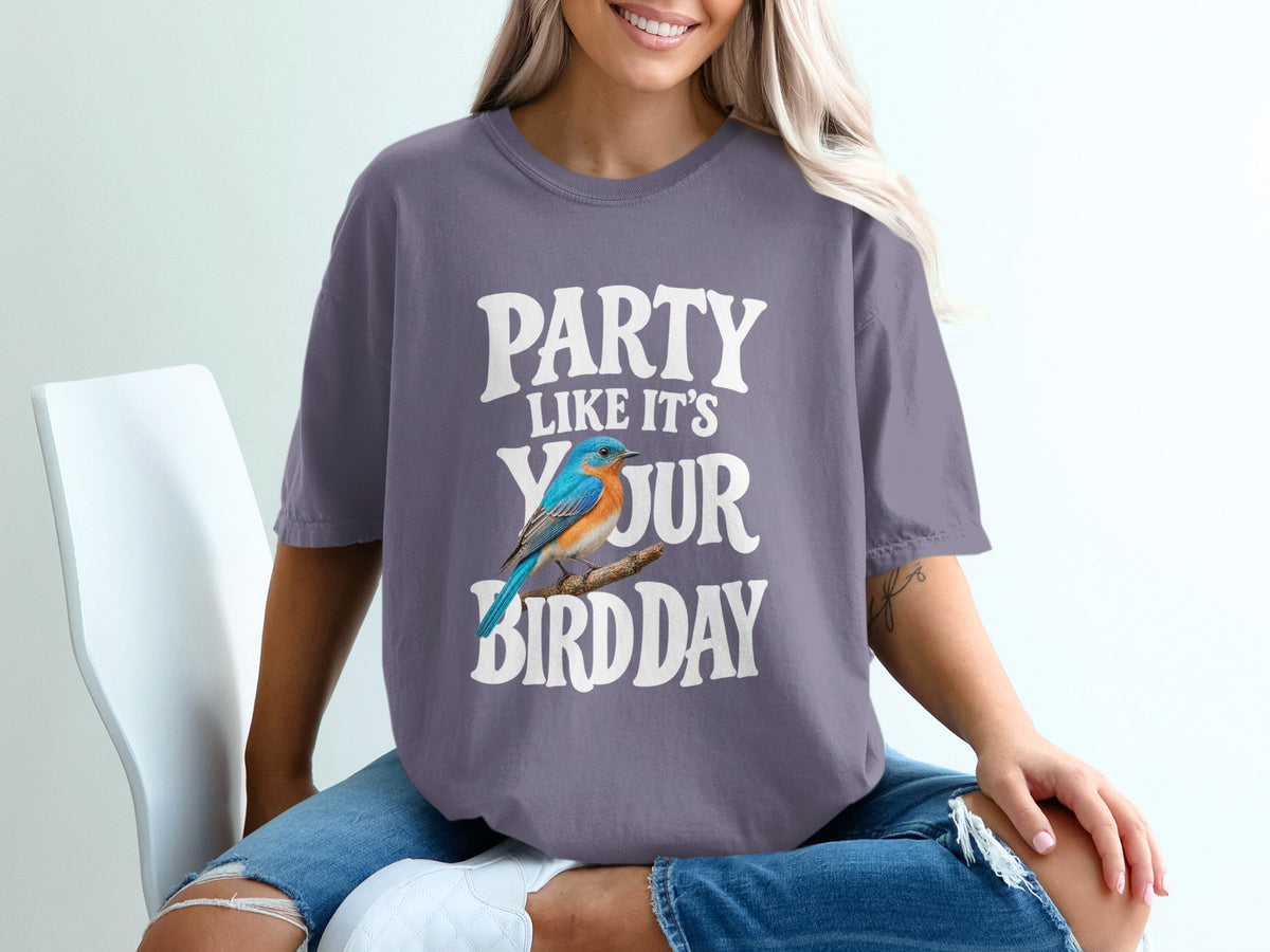 Purple t-shirt with white text "PARTY LIKE IT'S YOUR BIRD DAY" and a blue bird.