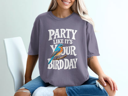 Purple t-shirt with white text "PARTY LIKE IT'S YOUR BIRD DAY" and a blue bird.