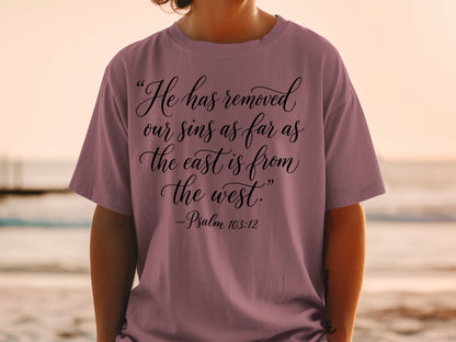 T-shirt with black script text "He has removed our sins as far as the east is from the west. -Psalm 103:12".