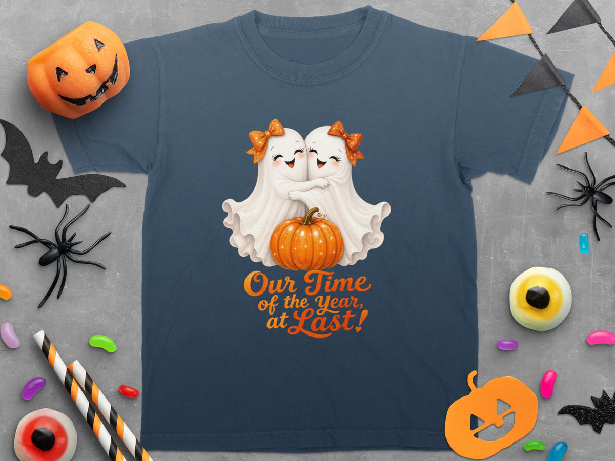 Two white ghosts hug a pumpkin with text "Our Time of the Year, at Last!".