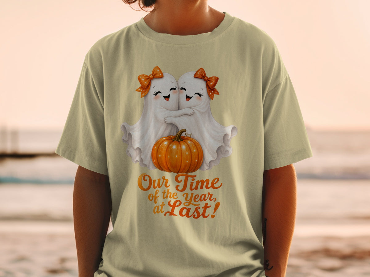 Two ghosts hug a pumpkin under text that reads "Our Time of the Year, at Last!"