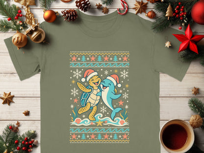 Green t-shirt with cartoon turtle and dolphin wearing Santa hats.