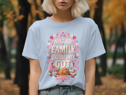 Light blue t-shirt with "Ain't No Family Like The One I Got" text and Thanksgiving dinner scene.
