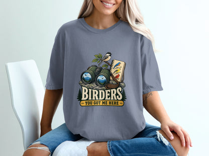 Binoculars, bird sketch, and text "BIRDERS YOU GOT ME HERE" on a t-shirt.