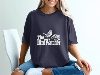 Dark t-shirt with white graphic of a bird and binoculars, text "The BirdWatcher".
