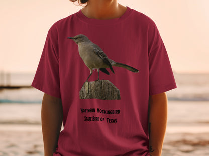 Maroon t-shirt with Northern Mockingbird, state bird of Texas graphic.
