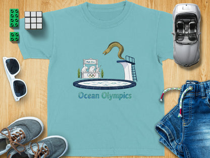 Blue t-shirt with cartoon moray eel on high dive and "Ocean Olympics" text.