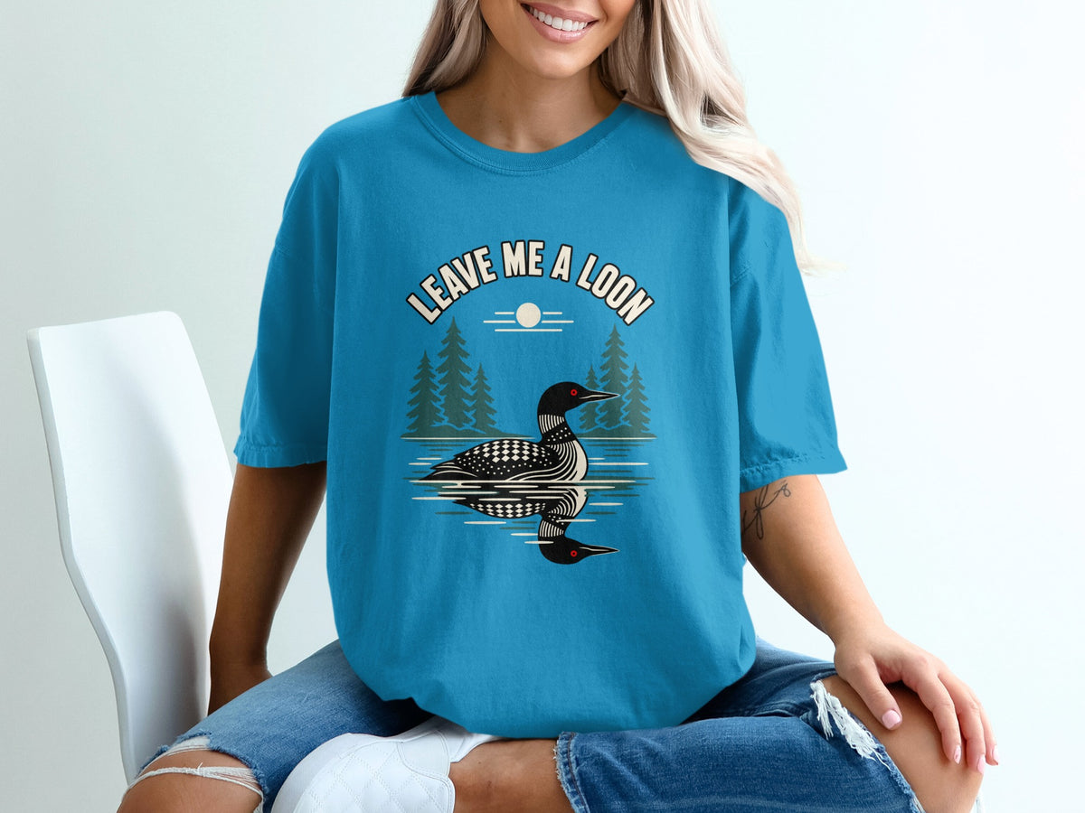 Teal t-shirt with a loon graphic and text "Leave Me A Loon".