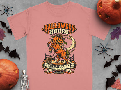 Pink t-shirt with "Halloween Rodeo Pumpkin Wrangler" graphic of a pumpkin horse.