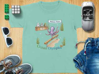 Teal t-shirt with octopus on balance beam, "Ocean Olympics" text.