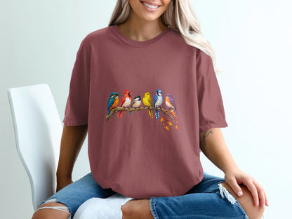 T-shirt with colorful birds perched on a branch with autumn leaves.