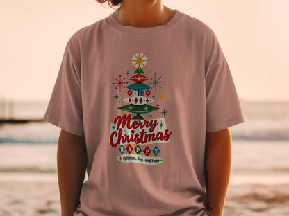 Retro Christmas tree graphic on a pink t-shirt with text "Merry Christmas Happy".
