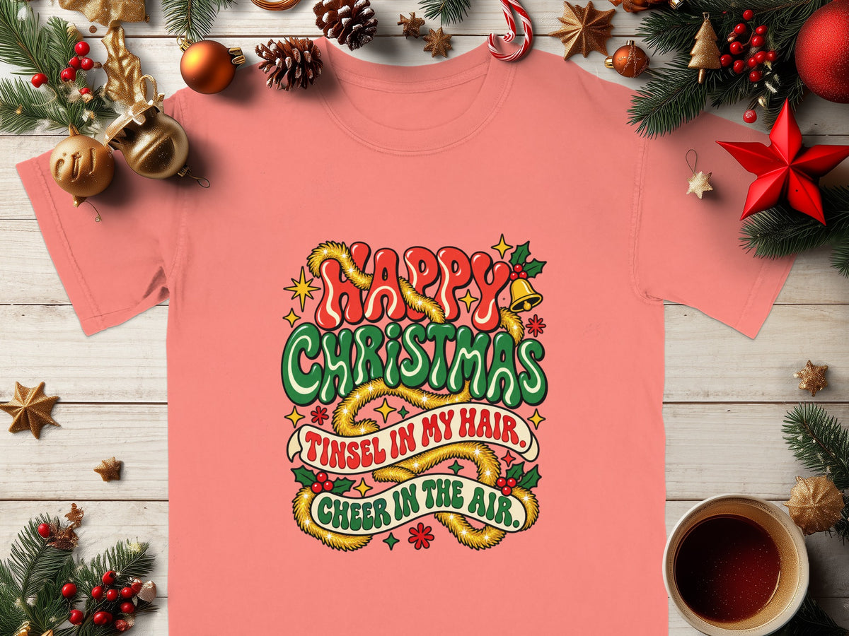 Coral t-shirt with "Happy Christmas, Tinsel in my hair, Cheer in the air" graphic.
