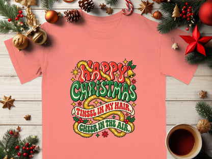 Coral t-shirt with "Happy Christmas, Tinsel in my hair, Cheer in the air" graphic.
