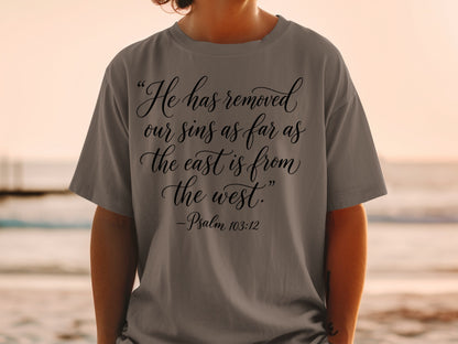 Gray t-shirt with "He has removed our sins as far as the east is from the west." - Psalm 103:12.