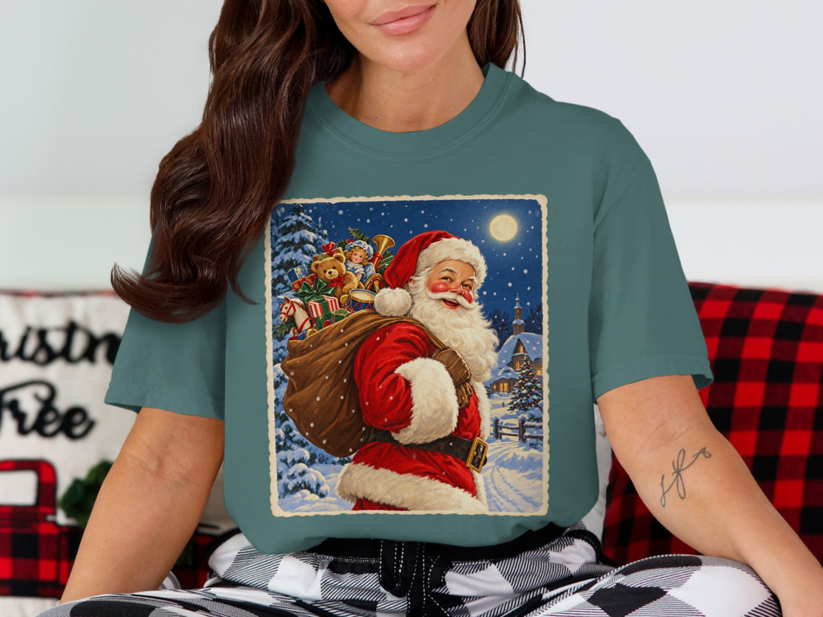 Vintage Santa Claus with sack of toys in snowy village scene on t-shirt.