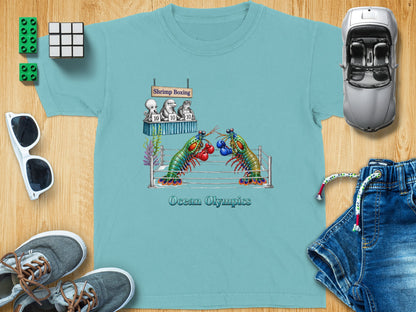 T-shirt graphic of shrimp boxing with text "Shrimp Boxing" and "Ocean Olympics."
