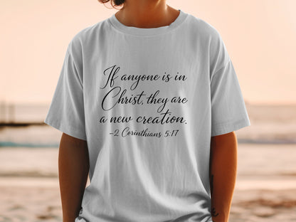 White t-shirt with "If anyone is in Christ, they are a new creation. -2 Corinthians 5:17"