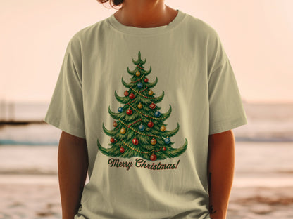 Light tan t-shirt with a green Christmas tree graphic and "Merry Christmas!" text.