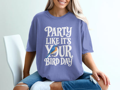 Purple t-shirt with white text "Party Like It's Your Bird Day" and a blue bird.