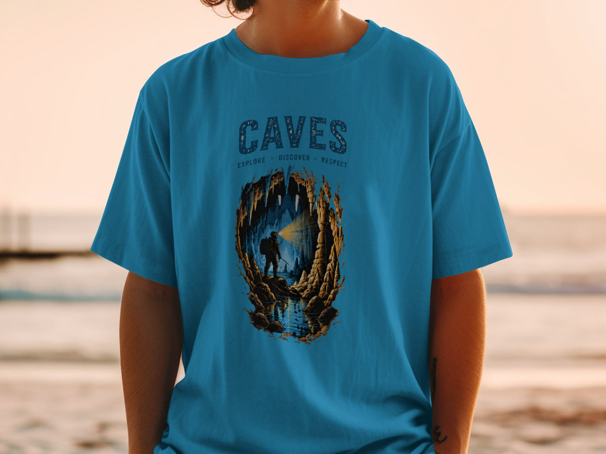 Blue t-shirt with "CAVES EXPLORE DISCOVER RESPECT" and cave explorer graphic.