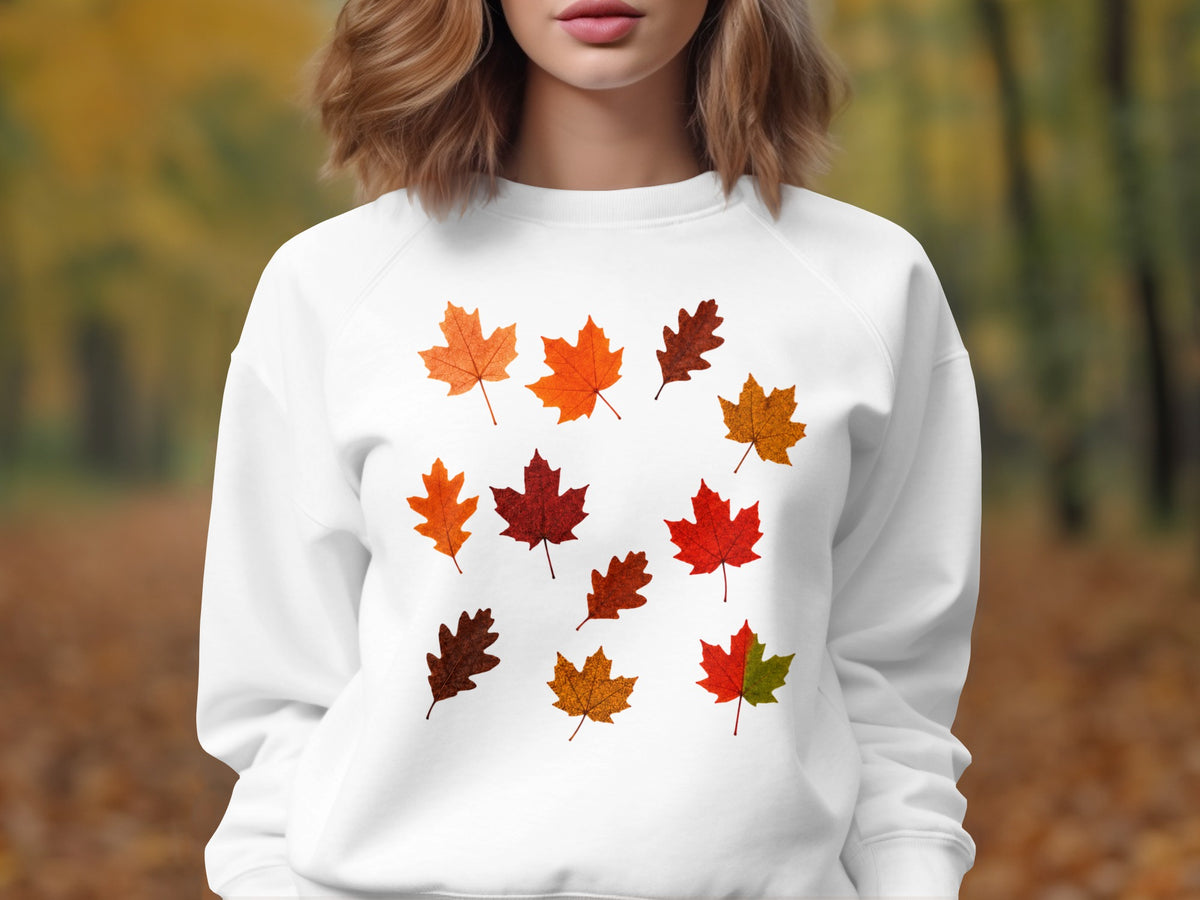 White sweatshirt with a scattered pattern of colorful fall leaves.