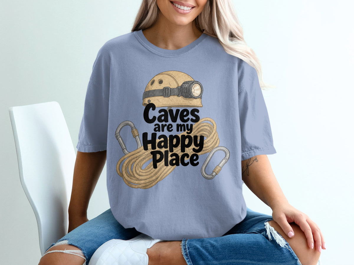 Blue t-shirt with text "Caves are my Happy Place" and caving gear graphic.