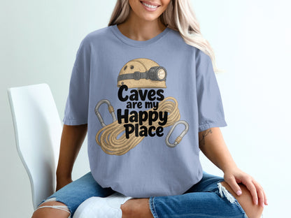 Blue t-shirt with text "Caves are my Happy Place" and caving gear graphic.