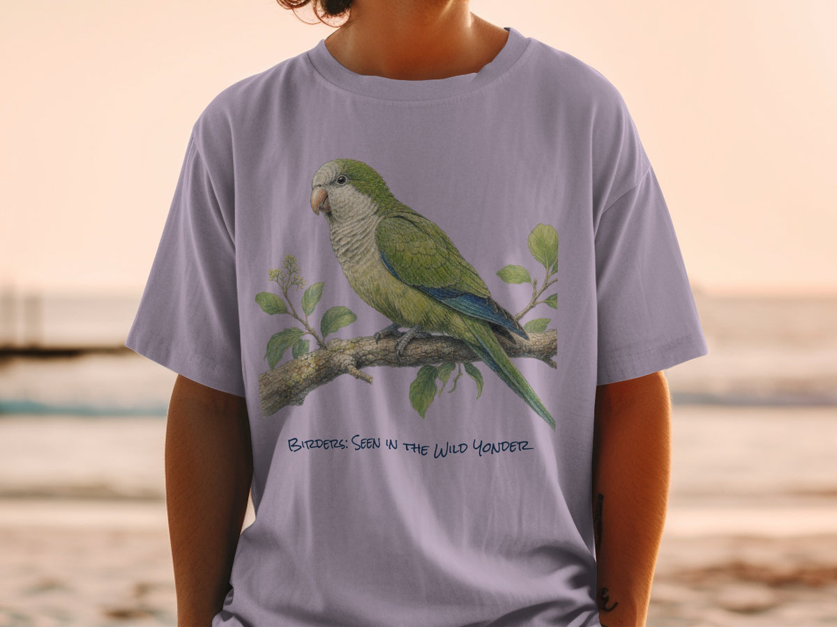 Light purple t-shirt with green parrot illustration and text "Birders: Seen in the Wild Yonder".