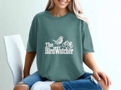 T-shirt with white "The BirdWatcher" text, a bird, and binoculars graphic.