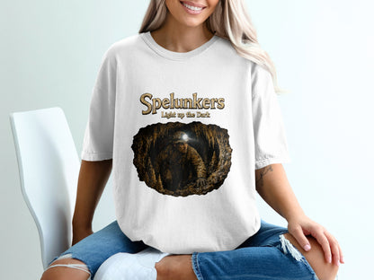Spelunkers Light up the Dark graphic on white t-shirt featuring a caver in a cave.