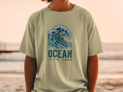 T-shirt with a graphic of a crashing ocean wave and text "OCEAN AIR SALT FREEDOM".