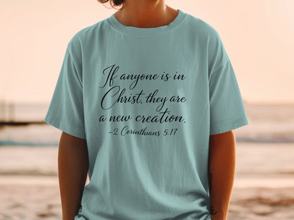 Light blue t-shirt with "If anyone is in Christ, they are a new creation."