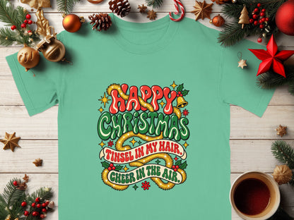 Mint t-shirt with "Happy Christmas" and "Tinsel in my hair, Cheer in the air" text.