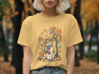 Orange and white cat with scarf sitting under autumn tree on yellow t-shirt.