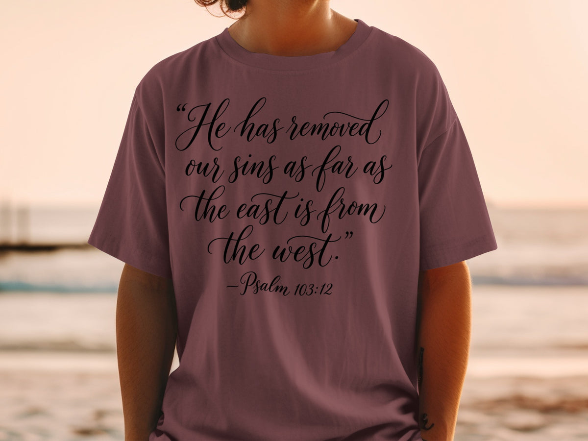 T-shirt with the text "He has removed our sins as far as the east is from the west." - Psalm 103:12.