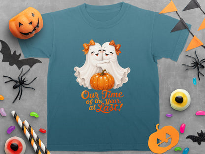 Teal t-shirt with two cute ghosts hugging a pumpkin, and text "Our Time of the Year, at Last!"
