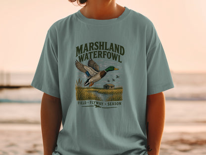 T-shirt with "Marshland Waterfowl Field Flyway Season" text and flying duck illustration.